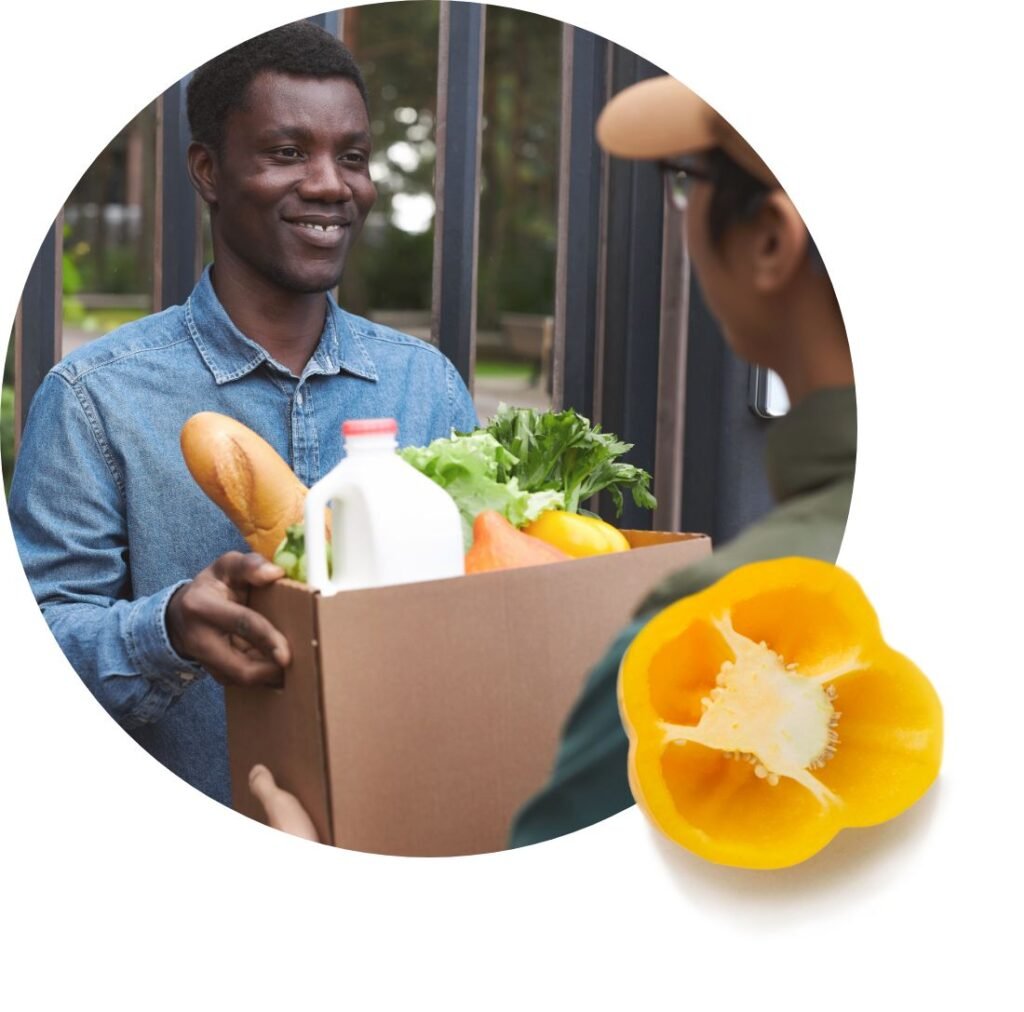 A person smiles while receiving a box of groceries—bread, milk, and fresh vegetables—from a delivery person, illustrating food assistance. A sliced yellow bell pepper is pictured in the corner.