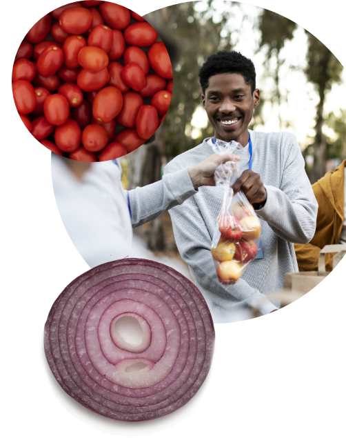 A smiling man receives a bag of apples at an outdoor market. Circular insets show grape tomatoes and a sliced red onion.