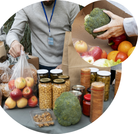 A person hands out fresh produce like apples and broccoli at a food distribution table, offering food assistance with fruits, canned goods, and jars of preserved food.